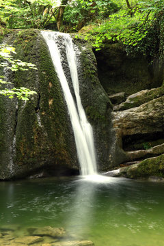 Janet’s Foss, a small waterfall near Malham North Yorkshire, Yorkshire Dales National Park. It carries Gordale Beck over a limestone outcrop topped by tufa into a deep pool below