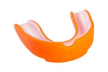 orange sports mouth guard, protection of teeth in box of rubber on white background, isolate
