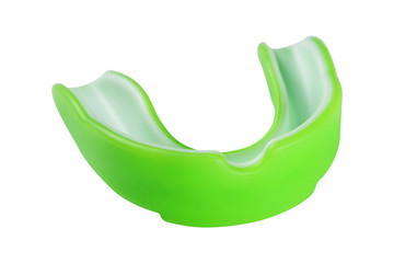 green sports mouth guard, protection of teeth in box of rubber on white background, isolate