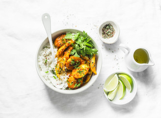 Potatoes and green beans curry sauce with rice and cilantro. Indian vegetarian healthy food on grey background, top view