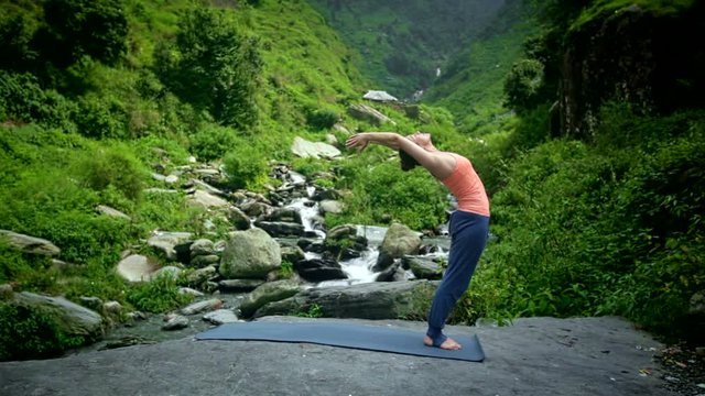 Woman doing yoga Sun Salutation Surya Namaskar