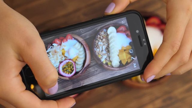 Female Hands Taking Photo Of Healthy Smoothie Bowl Breakfast With Smartphone