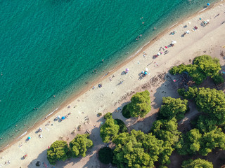 Beach with umbrellas and a bright water