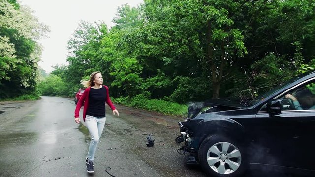 A young woman running towards the crashed car after an accident.