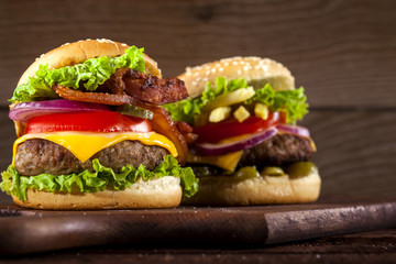 Fresh delicious burgers on a wooden background