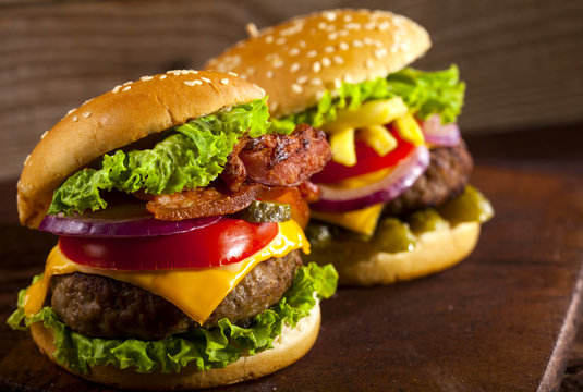 Fresh delicious burgers on a wooden background