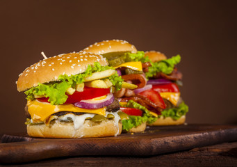 Fresh delicious burgers on a wooden background