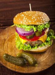 Fresh delicious burger on a wooden background