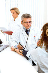 Fototapeta premium Offering his expert advice to his patient