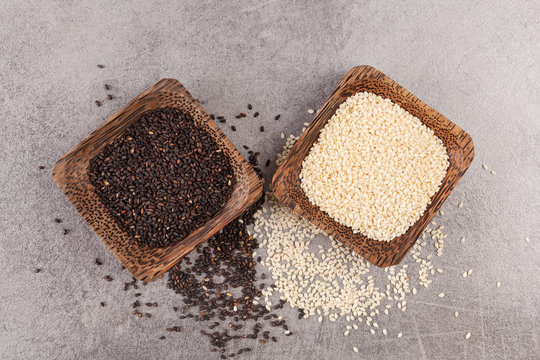 Black and white sesame seeds on grey background. Healthy eating.