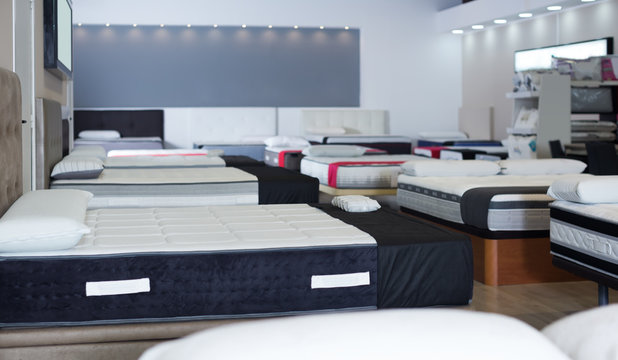 Image of new mattresses on the beds in the store