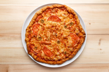 Homemade pizza on wooden table. Top view. Flat lay. Copy space