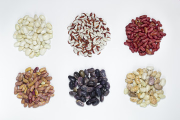 Beans of different varieties on a white background. Multicolored bean top view. 