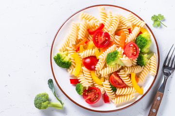 Vegan pasta fusilli with vegetables. Top view.