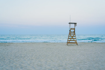 Lifeguard watchtower on the beach at sunset.