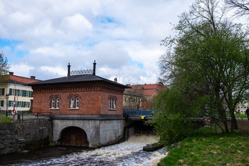 The view of an old buildin,the bridge and trees in the center of Vasteras, Sweden,  on a sunny spring day
