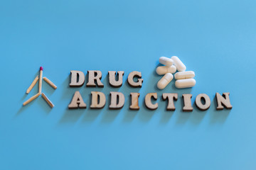 drug addiction concept. human figure, drugs, drug addiction on a blue background