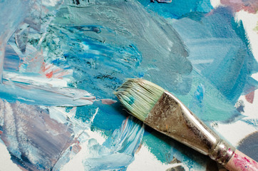 Artist paint brush on the wooden palette