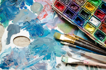 Fototapeta premium Artist paint brushes and watercolor paintbox