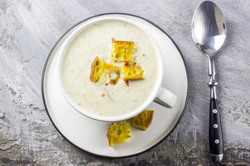 mushroom cream soup on white wooden board. top view