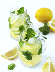 Mason jar glass of lemonade with mint on white background