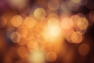 Fototapeta premium Bright round bokeh on orange background