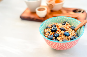 High protein healthy breakfast, buckwheat porridge with blueberries, flax seeds and honey