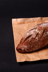 Tasty daily bread on black background. Close view