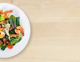 Green salad with shrimps on background