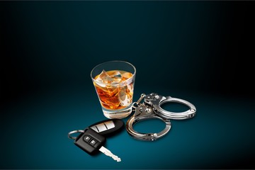 Whiskey with car keys and handcuffs concept