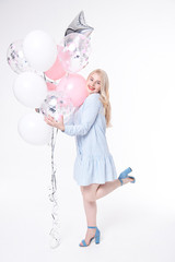 Smiling beautiful woman having fun with balloons.