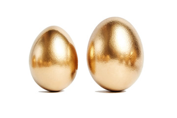 Two golden eggs isolated on white background. Conceptual image