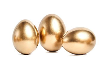 Three golden eggs isolated on white background. Conceptual image