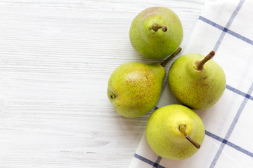 Fresh pears on a white wooden table, overhead view. Copy space.