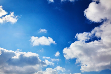 The blue sky with clouds. Spring, winter or summer heaven. Vivid background
