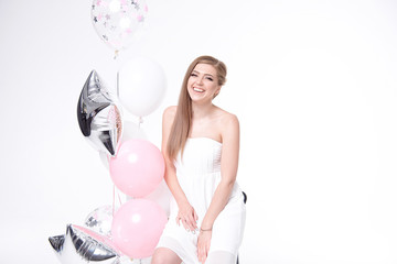 Smiling beautiful woman having fun with balloons.