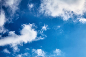 The blue sky with clouds. Spring, winter or summer heaven. Vivid background