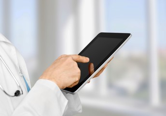 Doctor at hospital working on tablet