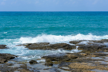 Fototapeta na wymiar view of the Mediterranean horizon and the waves with foam breaking on the coastal stones