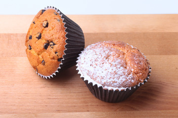 Homemade Blueberry muffins with powdered sugar and fresh berries.