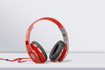 Red headphones on white desk