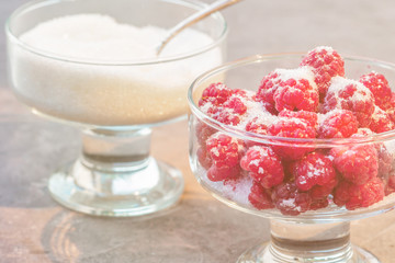 Glass of fresh raspberries sprinkled with white sugar gardening gastronomy harvest