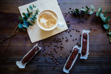 Cappuccino, eclairs and flowers.