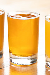 Side close up on a row of golden pale ale beers