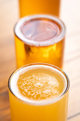 Close up on the surface of a craft beer with lager in the background, and space for text on top