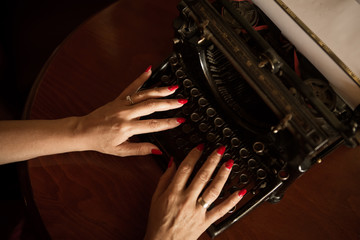 Hands on the old typewriter.