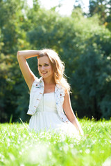 Obraz premium Young beautiful blonde woman in white dress