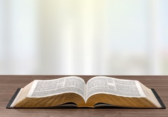 Open book on old wooden table
