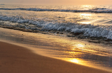 Sunset over the sea. Reflection of sunlight in the sea waves. Red sky in the rays of the sunset.