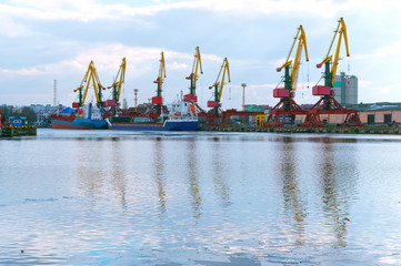 Seaport on the Baltic sea. Сommercial port. Port cranes and machinery.